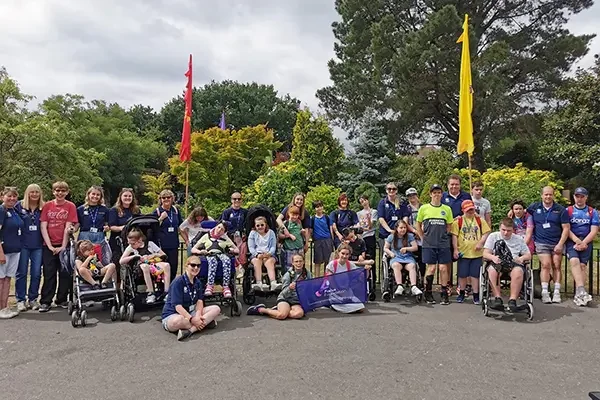 join the champions of change Large group volenteering for the Focus Foundation with disabled children
